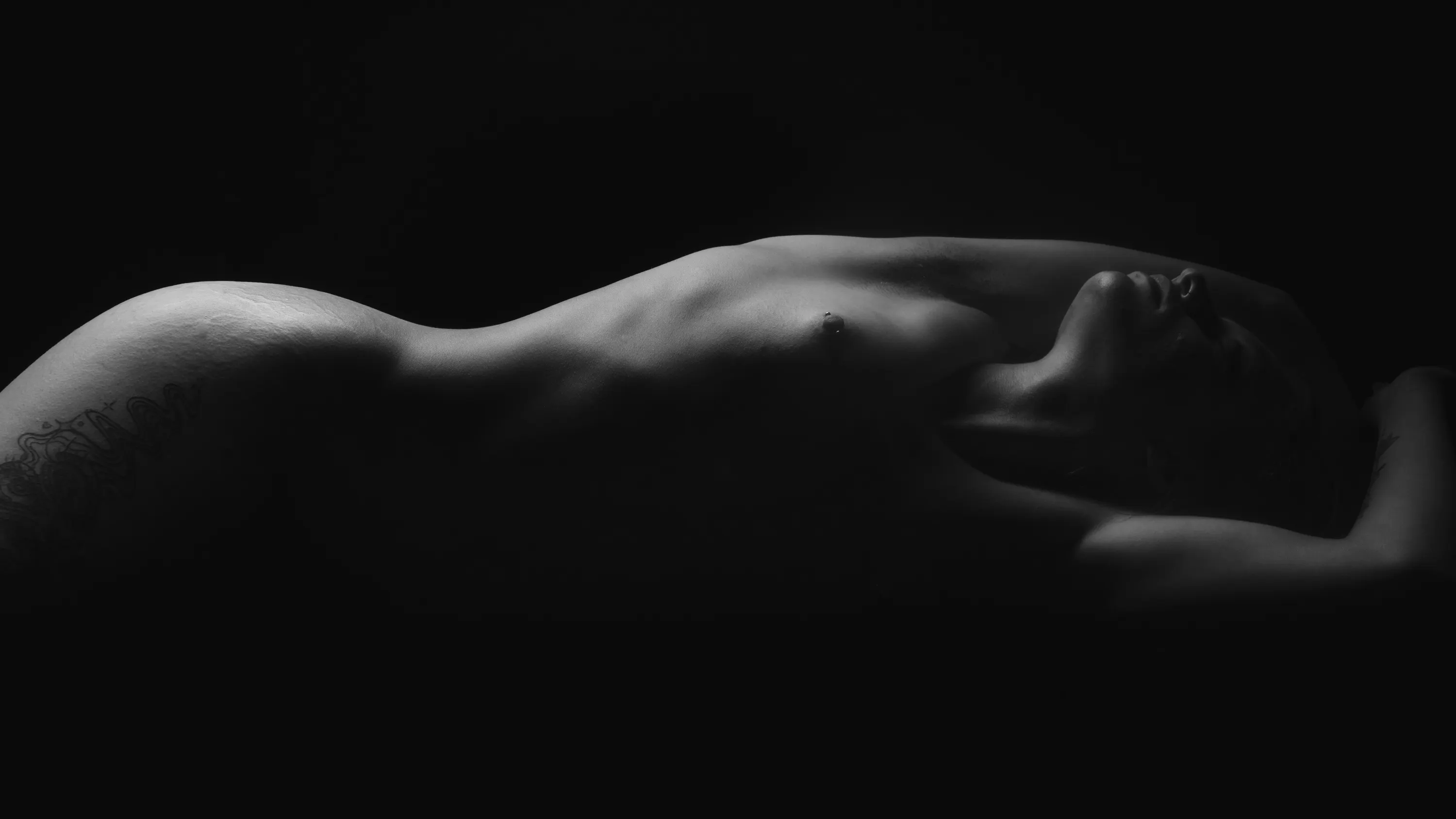 Bodyscape photo of a woman lying on her back.