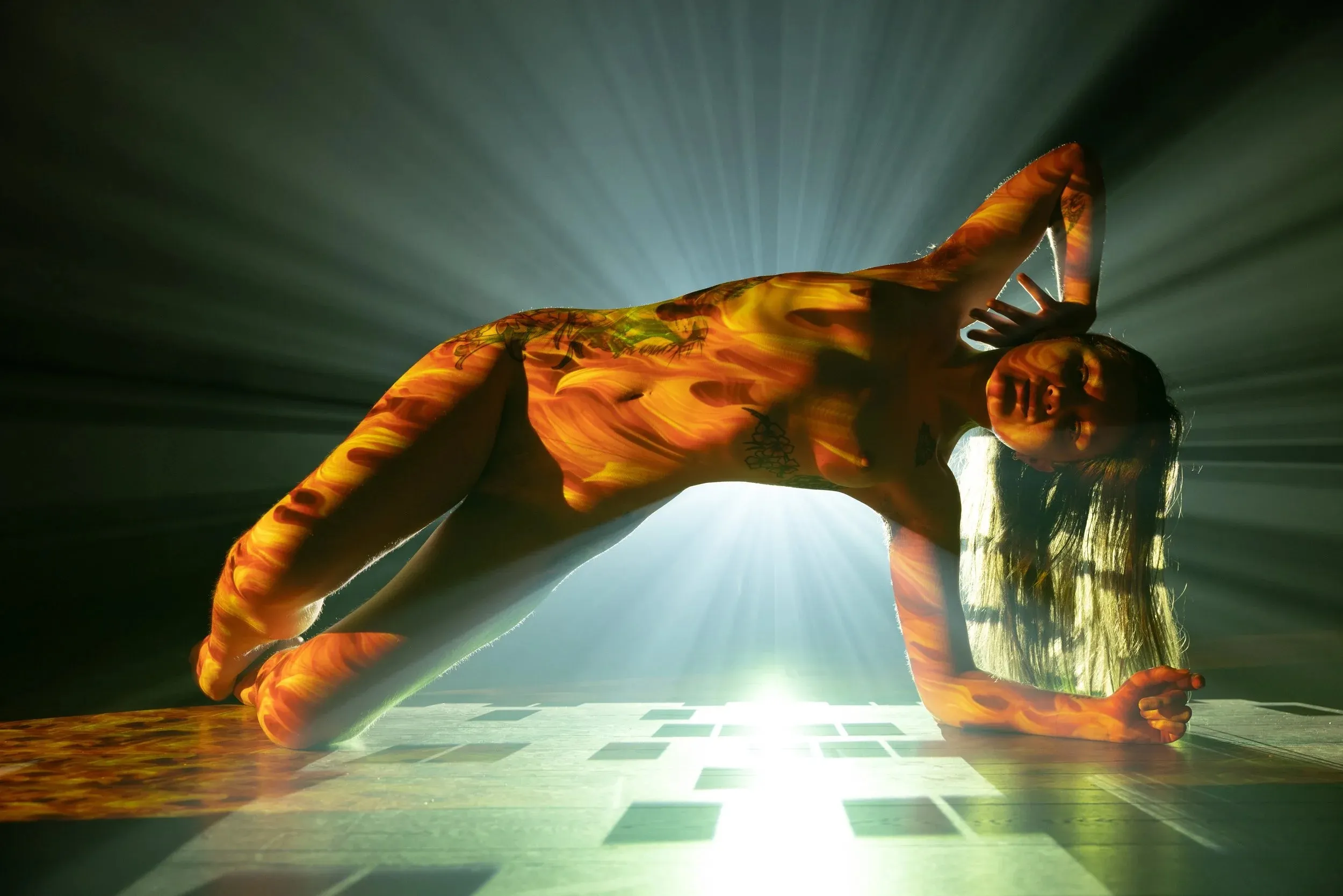 A figure forms a bridge above a projector and green-white rays.