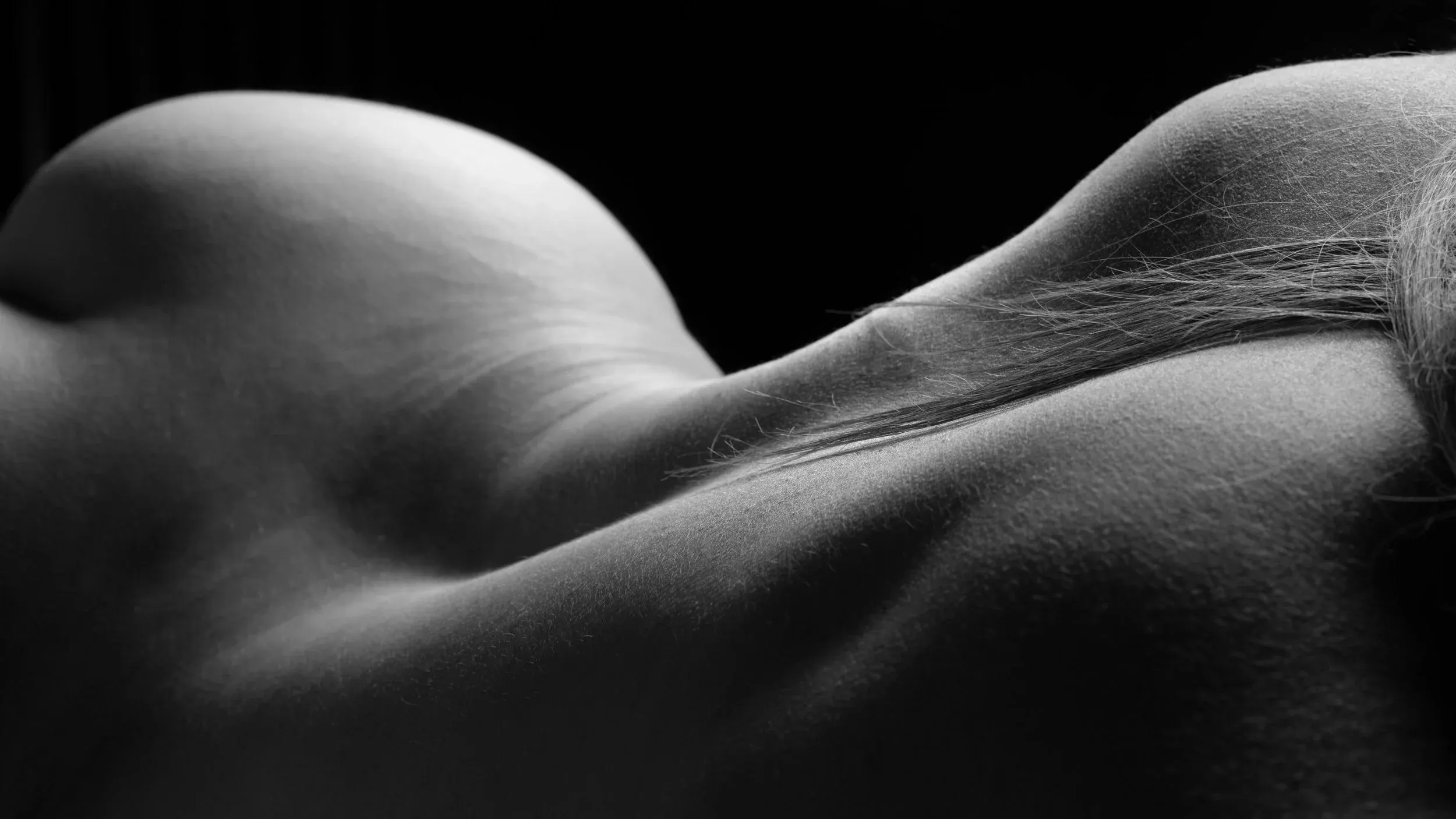 A reclining bodyscape becomes a rolling black-and-white landscape.