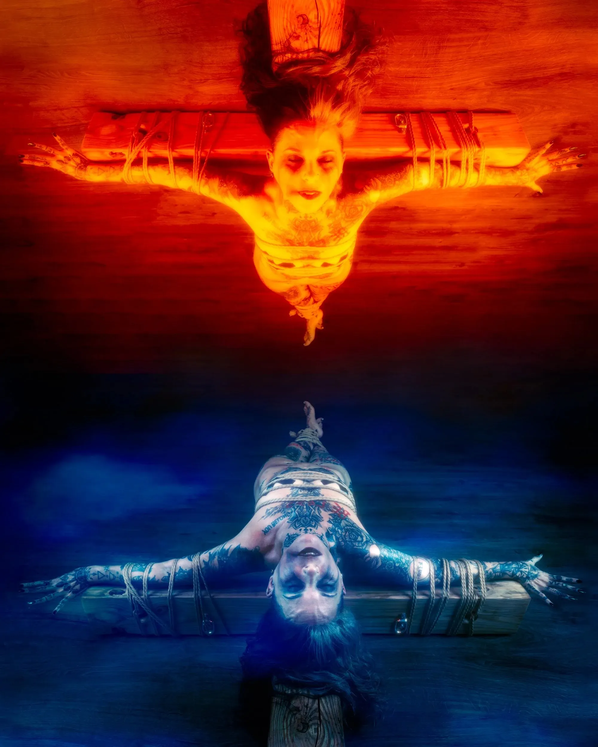 Mirrored blue and orange tinted images of a woman bound to a cross.