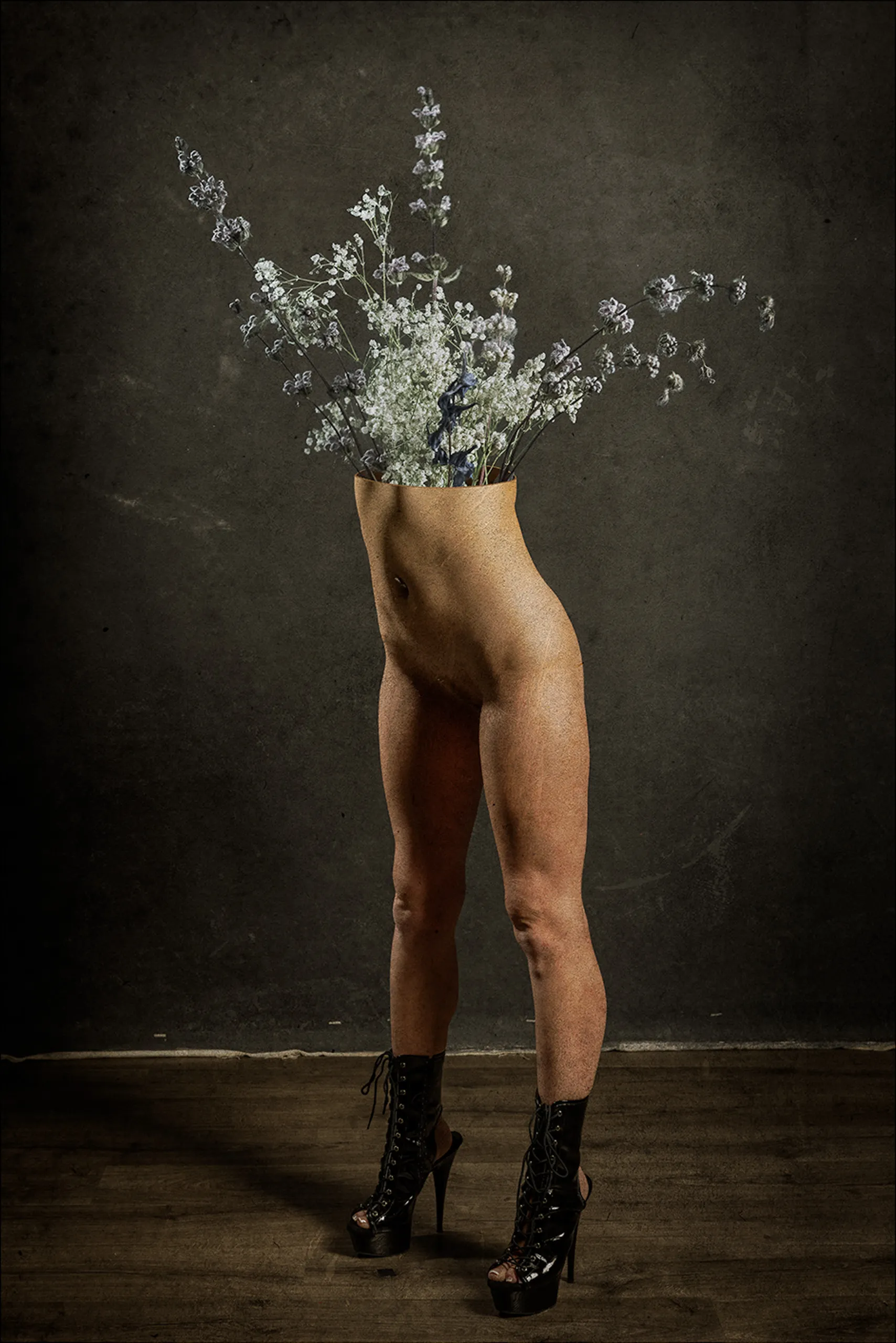A surreal standing figure in black boots transforms into a spray of white flowers.