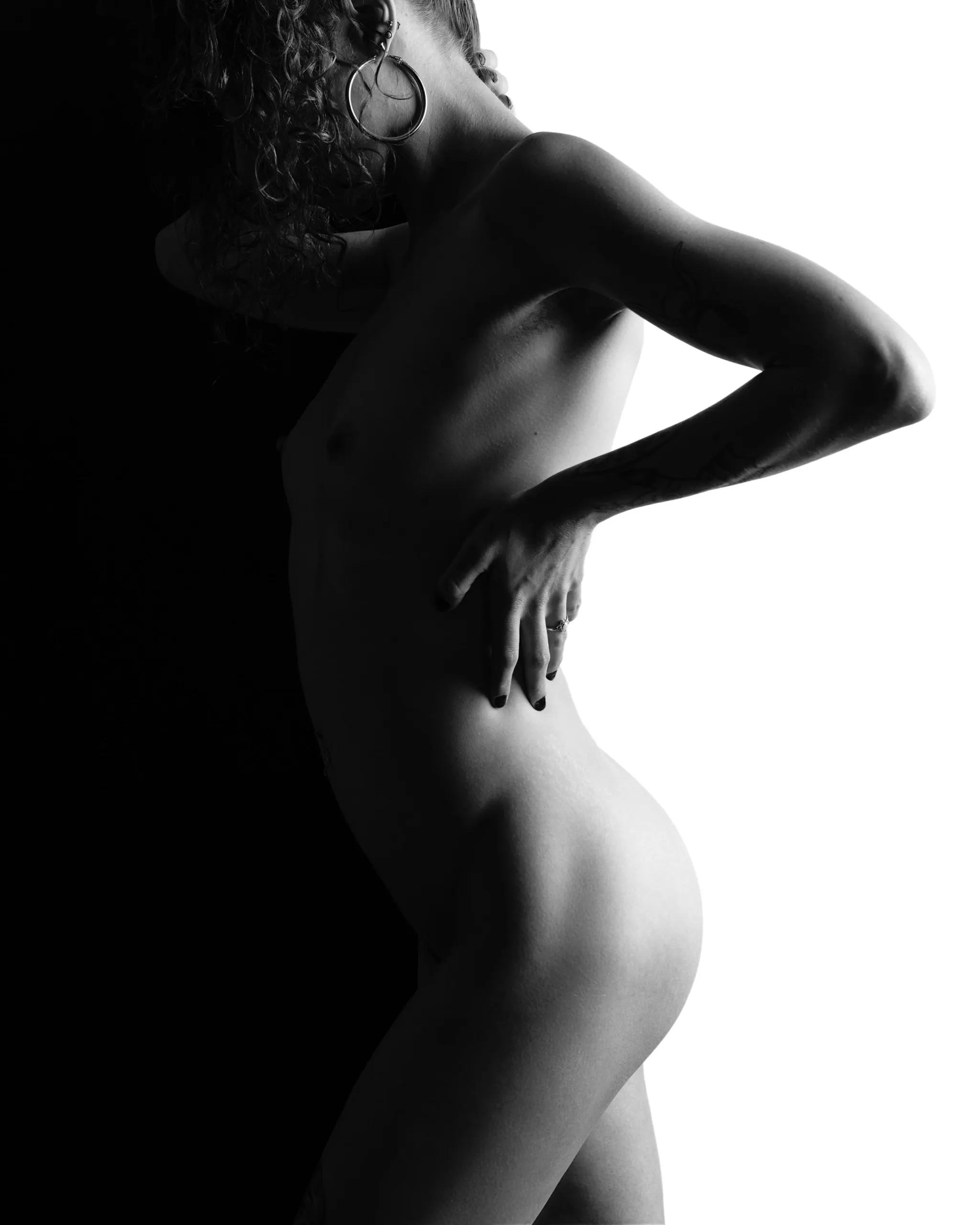 A black-and-white profile is silhouetted against a bright white background.