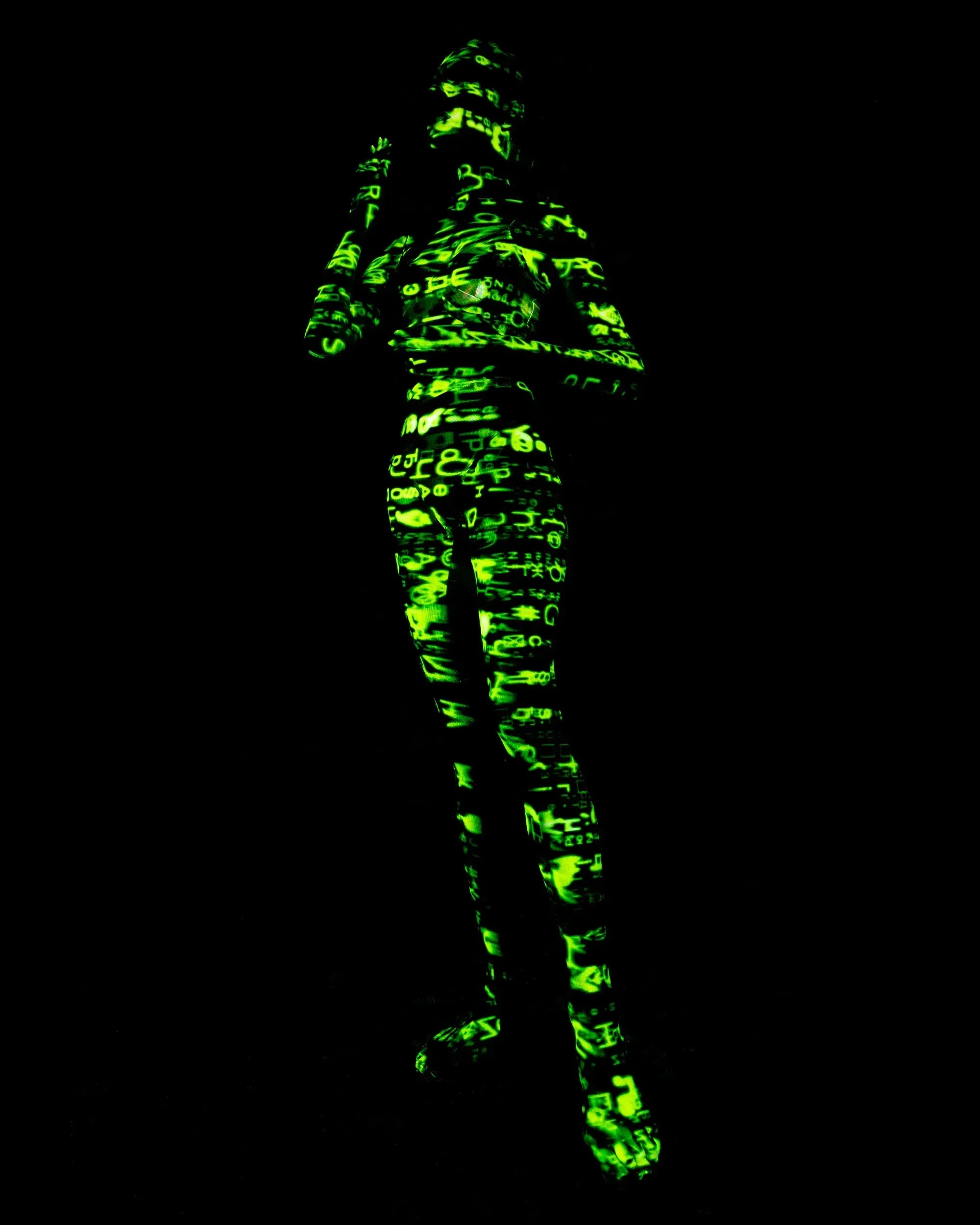 Matrix-like projection onto the body of a standing woman.