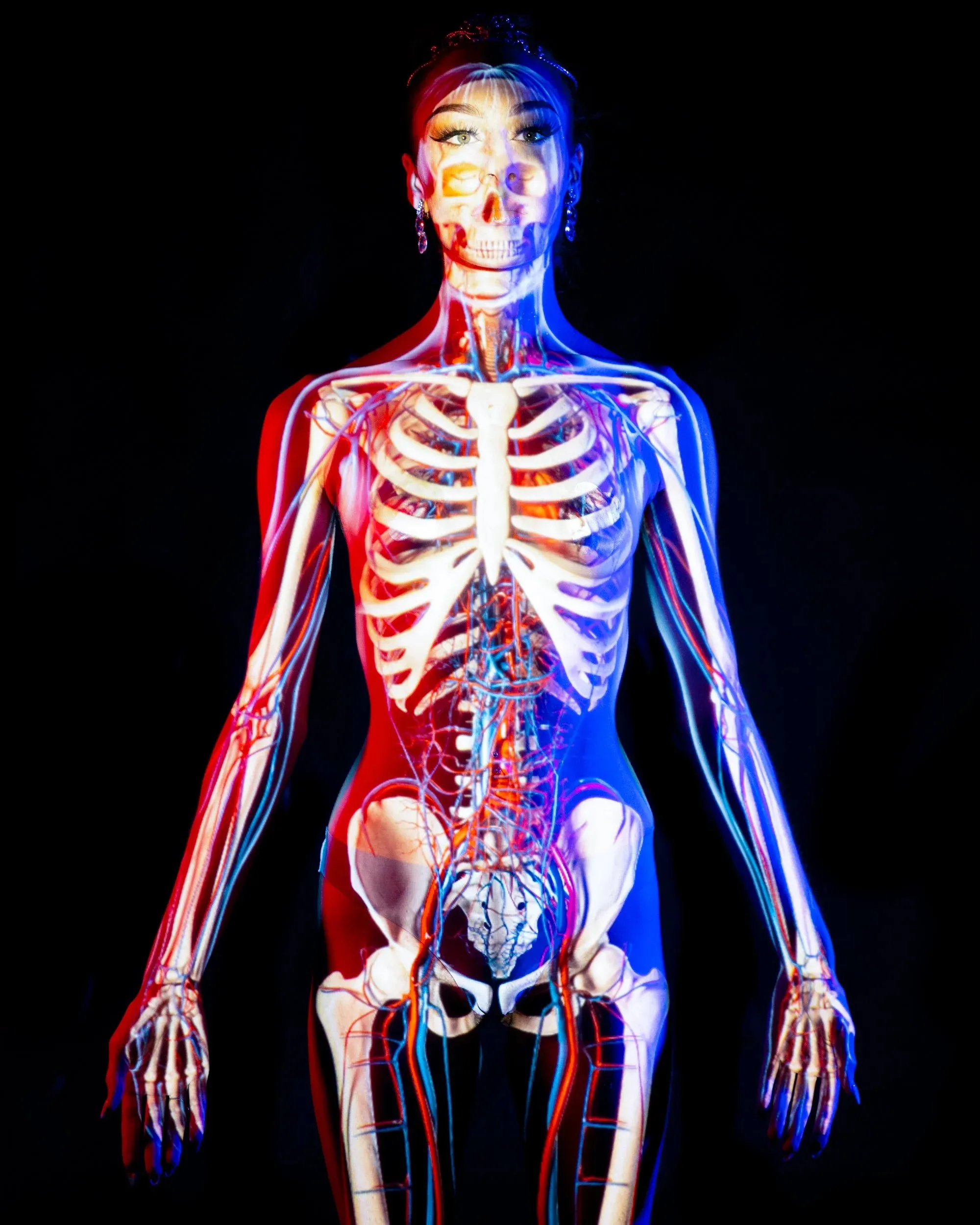 A bright skeleton and red-blue edge light cover a front-facing figure.