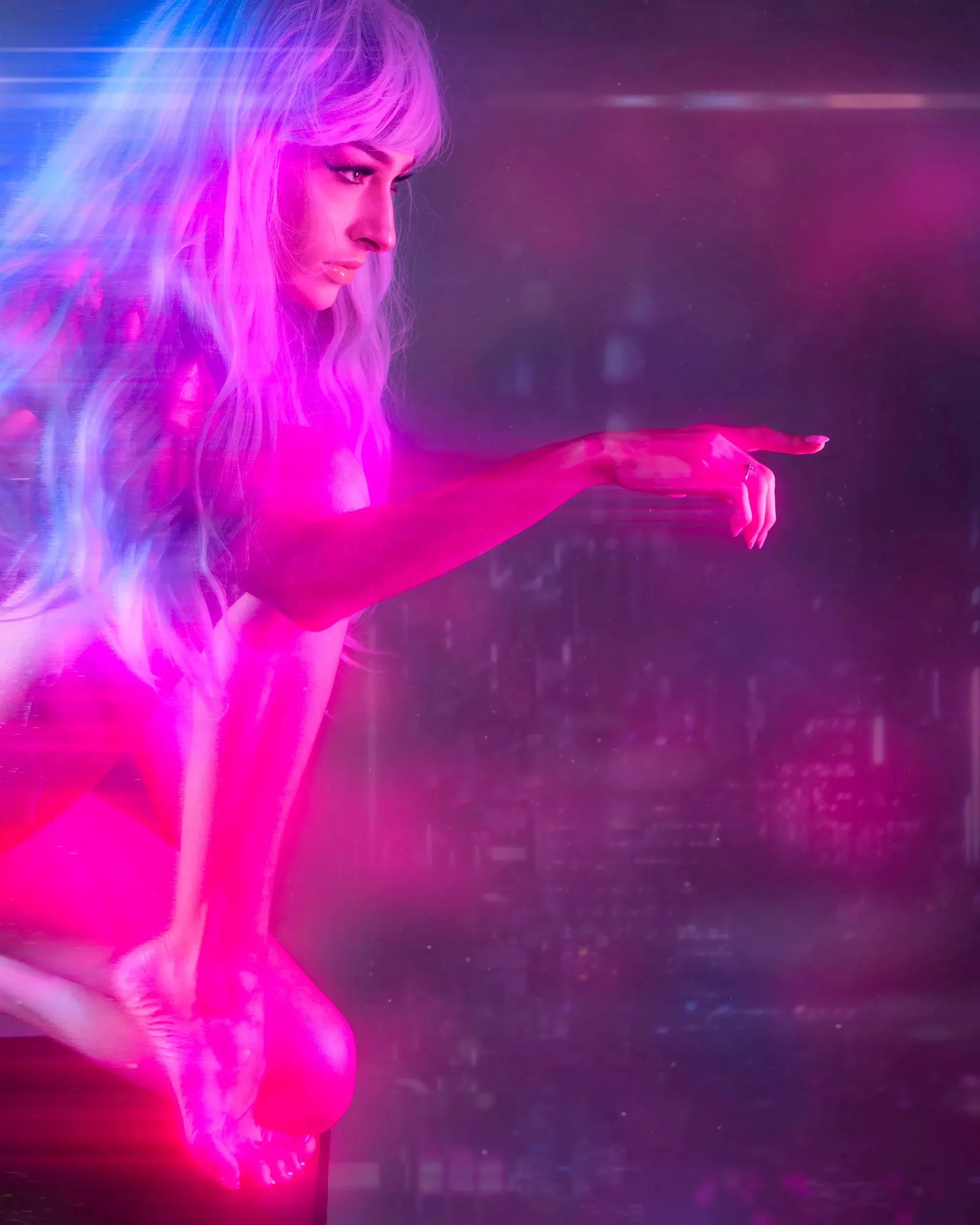 A woman points through saturated pink and blue haze.