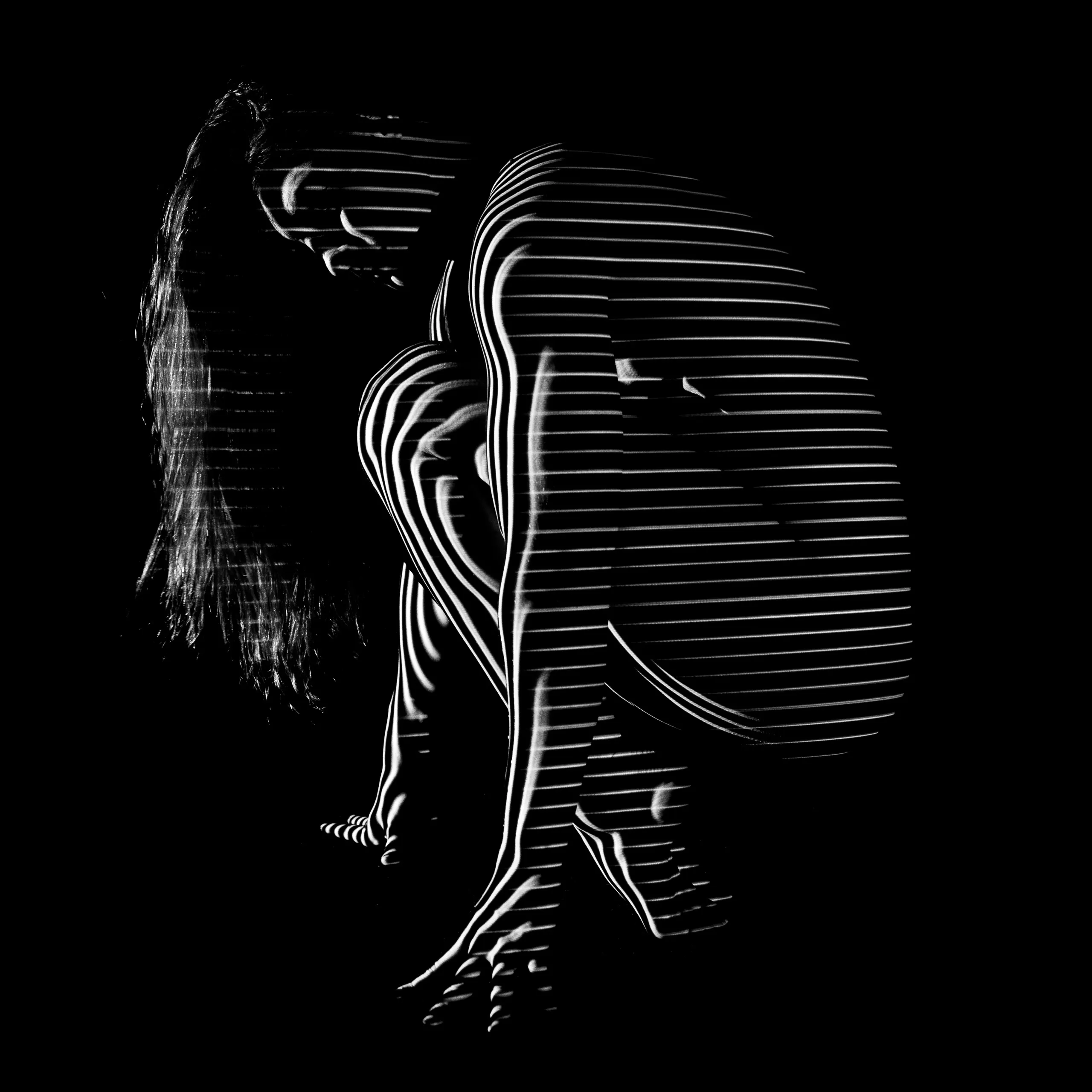 A close view of a crouched woman seen from the side, horizontal bands of light wrapping her body.