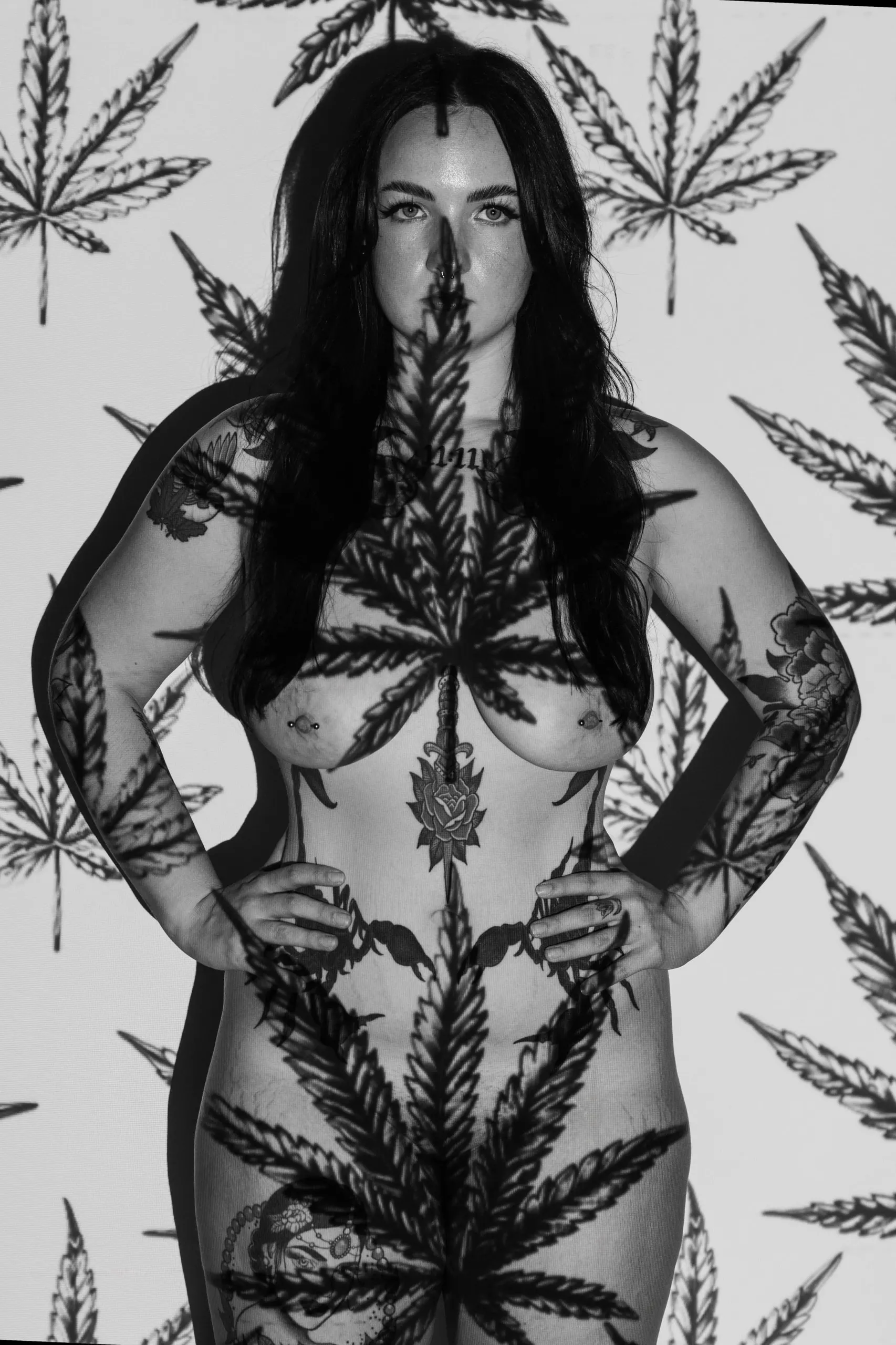 A black-and-white portrait merges a woman with a repeating cannabis-leaf pattern.