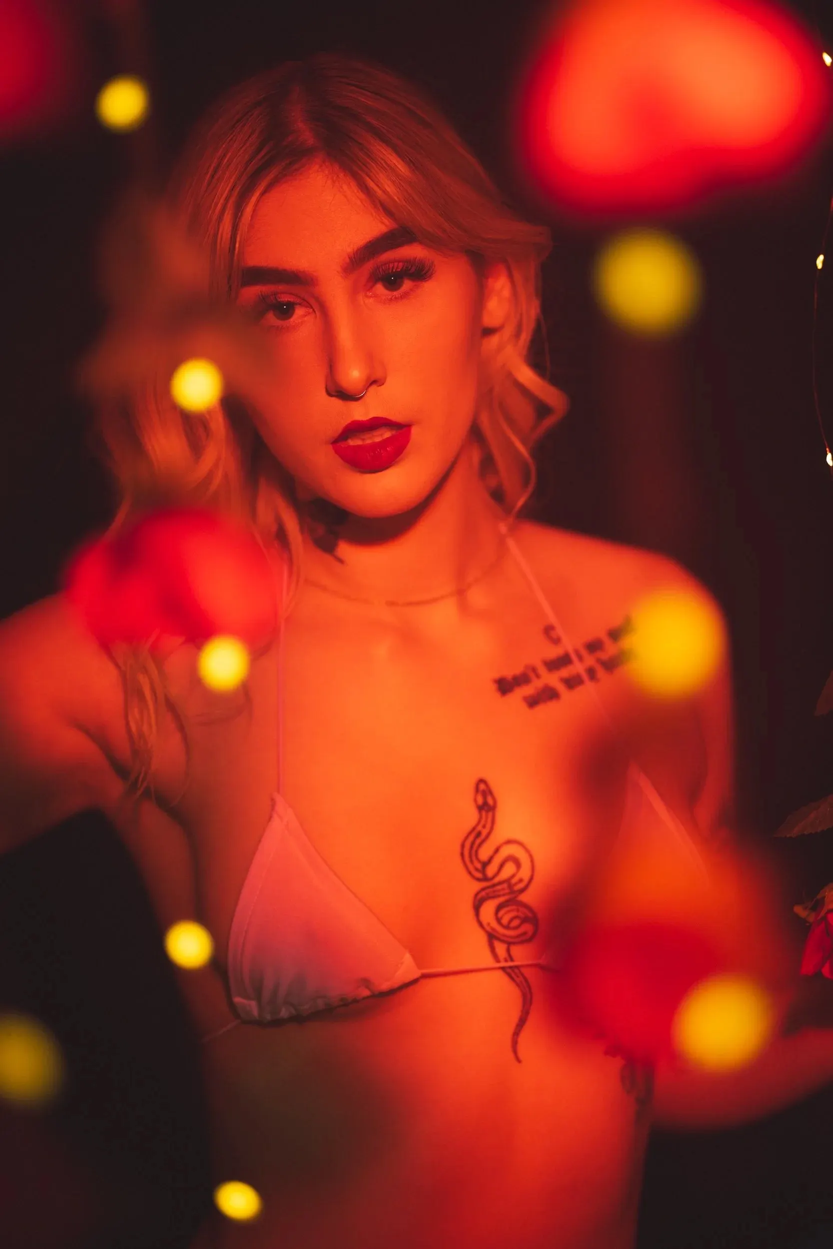 A close vertical portrait frames a serious gaze through warm bokeh.